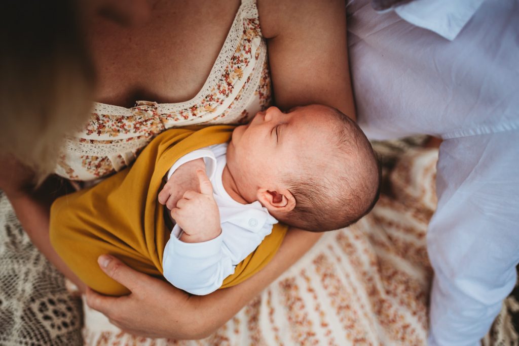 outdoor newborn photography during sunset. Sleeping newborn baby