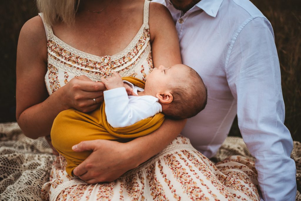 newborn baby wrapped up in a mustard blanket