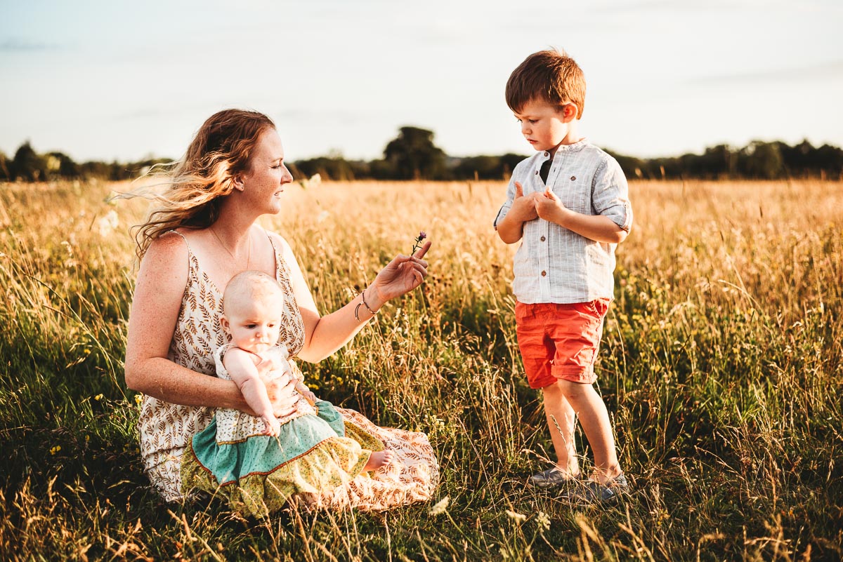 mother and her two children in a wild meadow