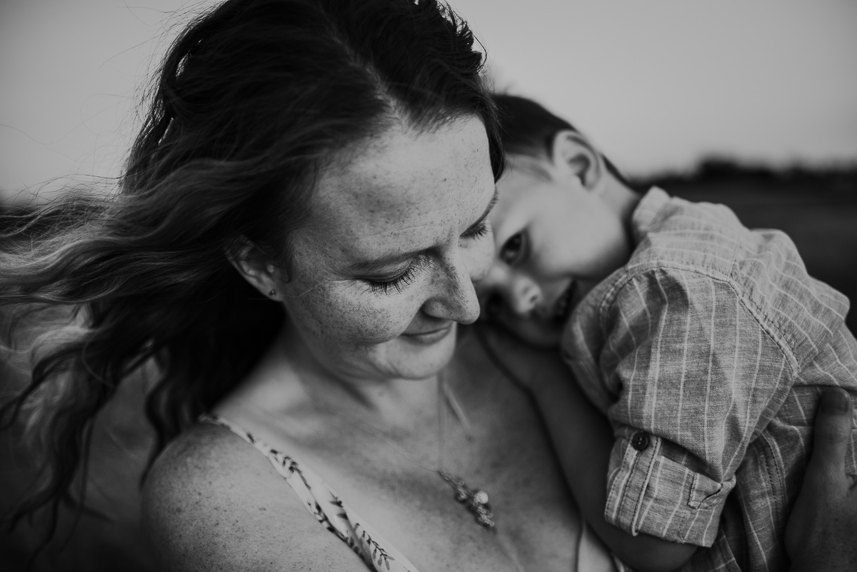 black and white image of a mother and her son cuddling