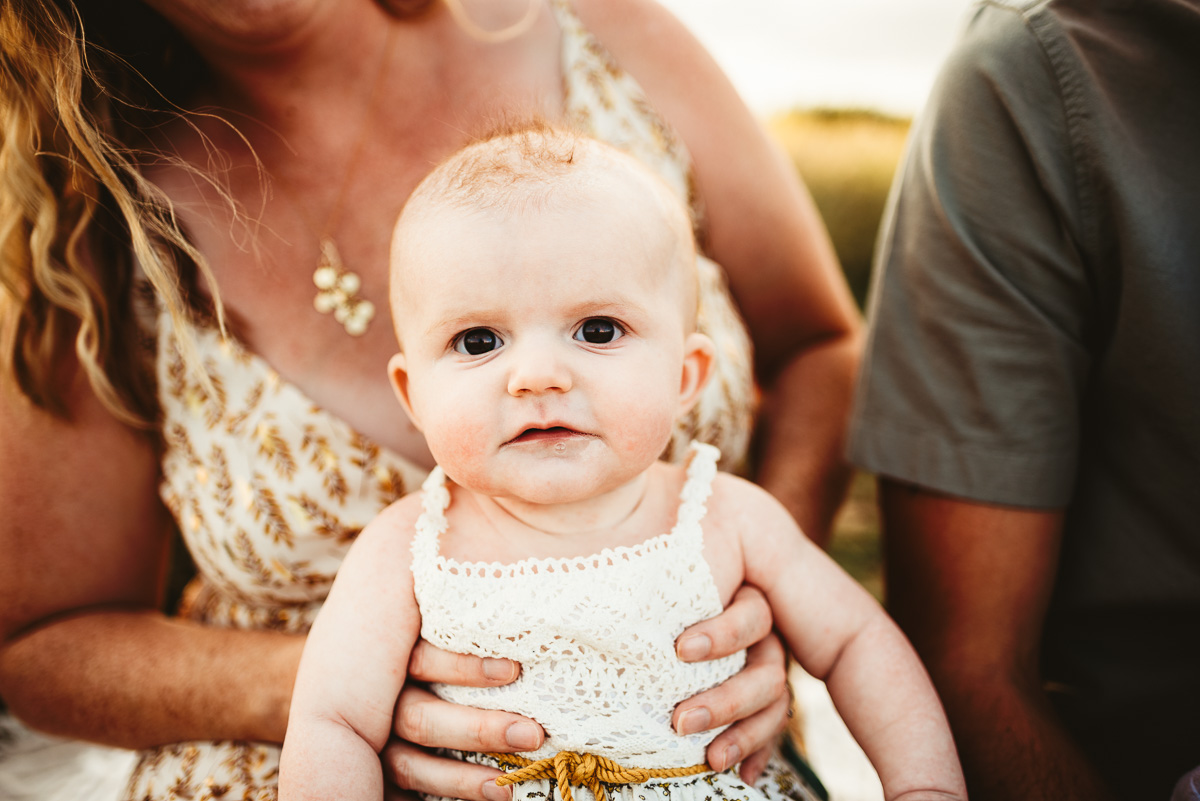 little baby girl sitting on her mothers lap