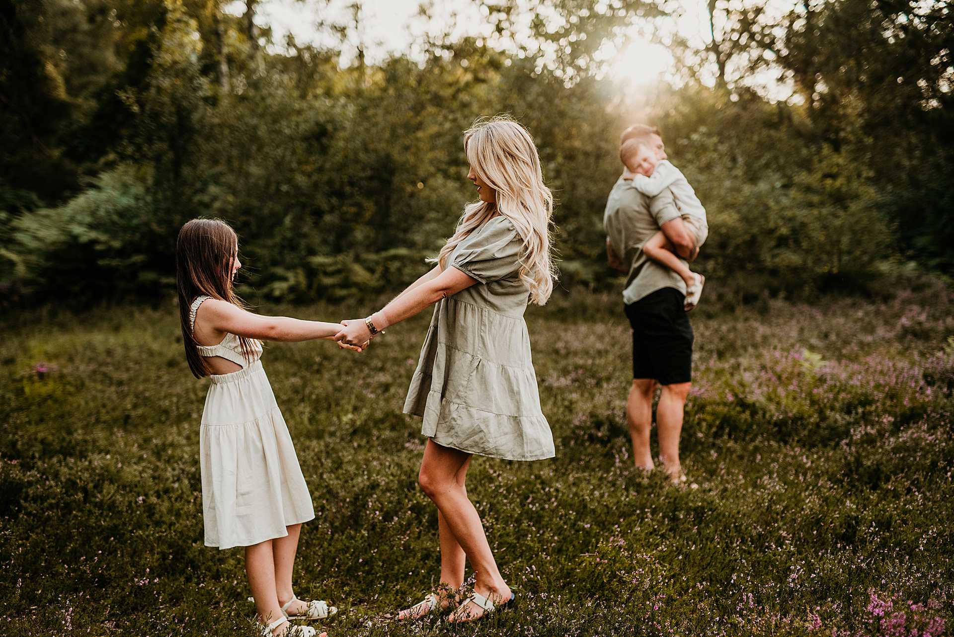 mother and daughter singing around together with dad and son in the background