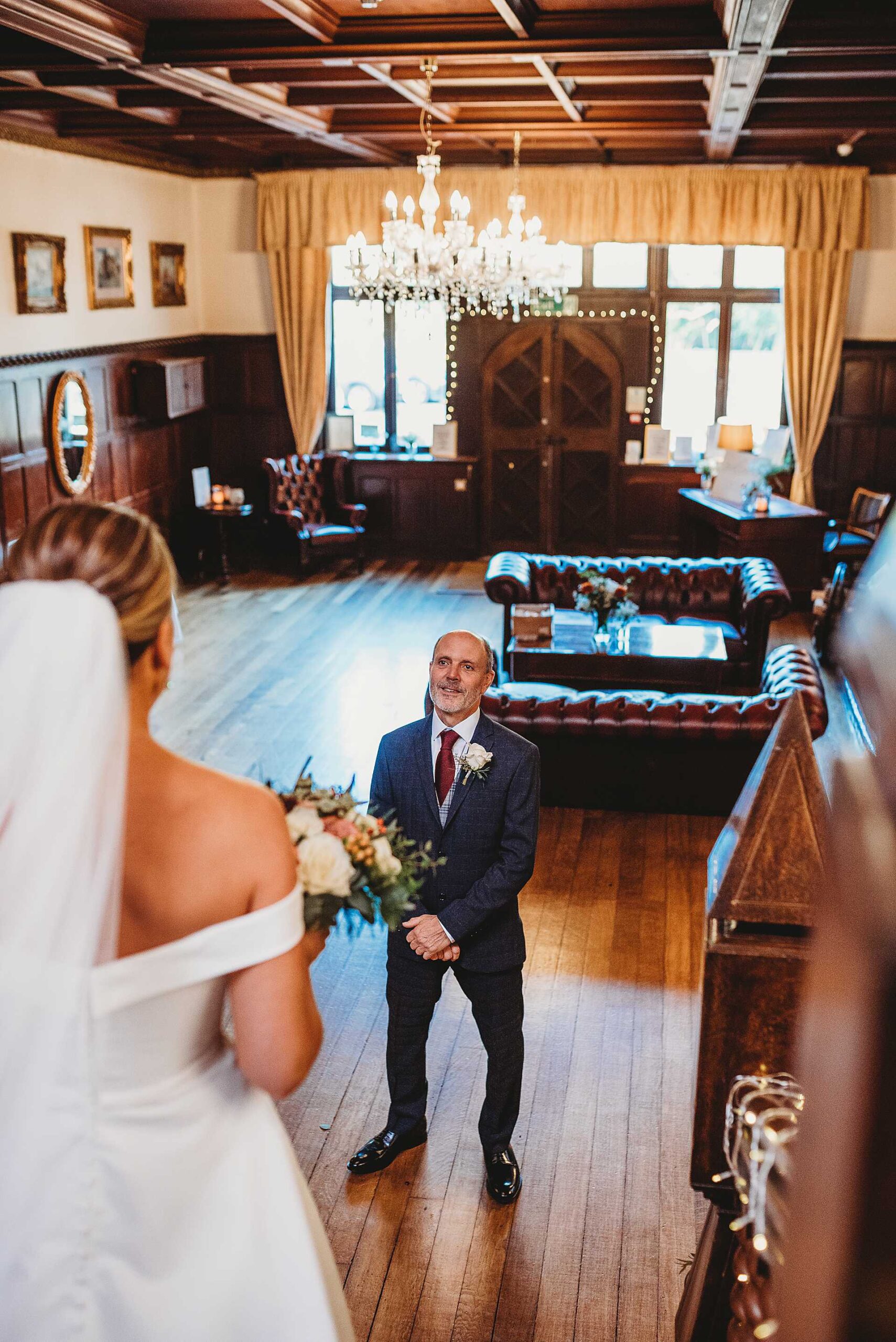 bride walking down the stairs to meet her dad at Highley Manor