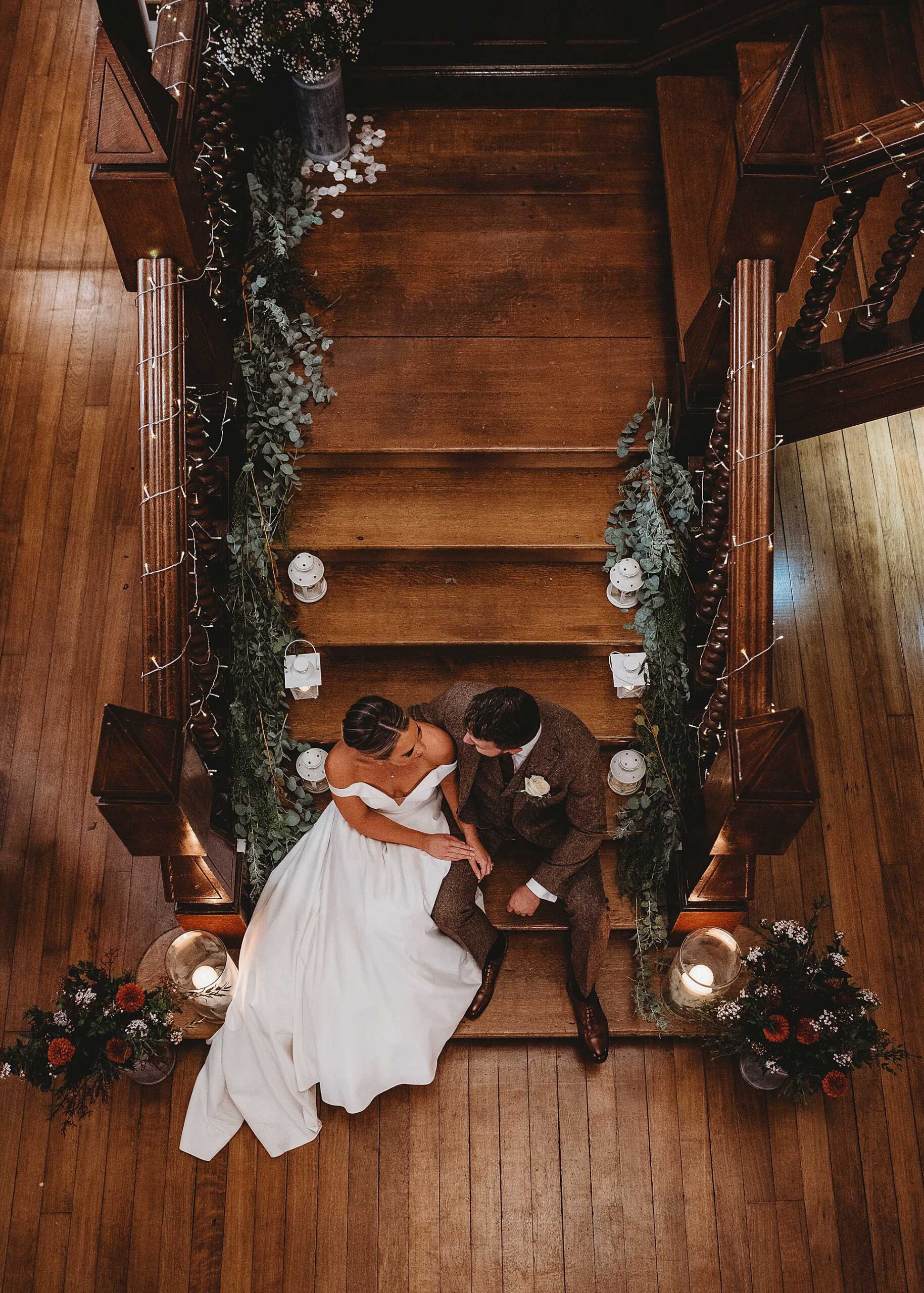 bride and groom sitting on the steps at Highley Manor