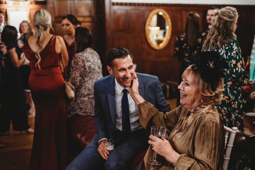 guest laughing at a wedding at highly manor