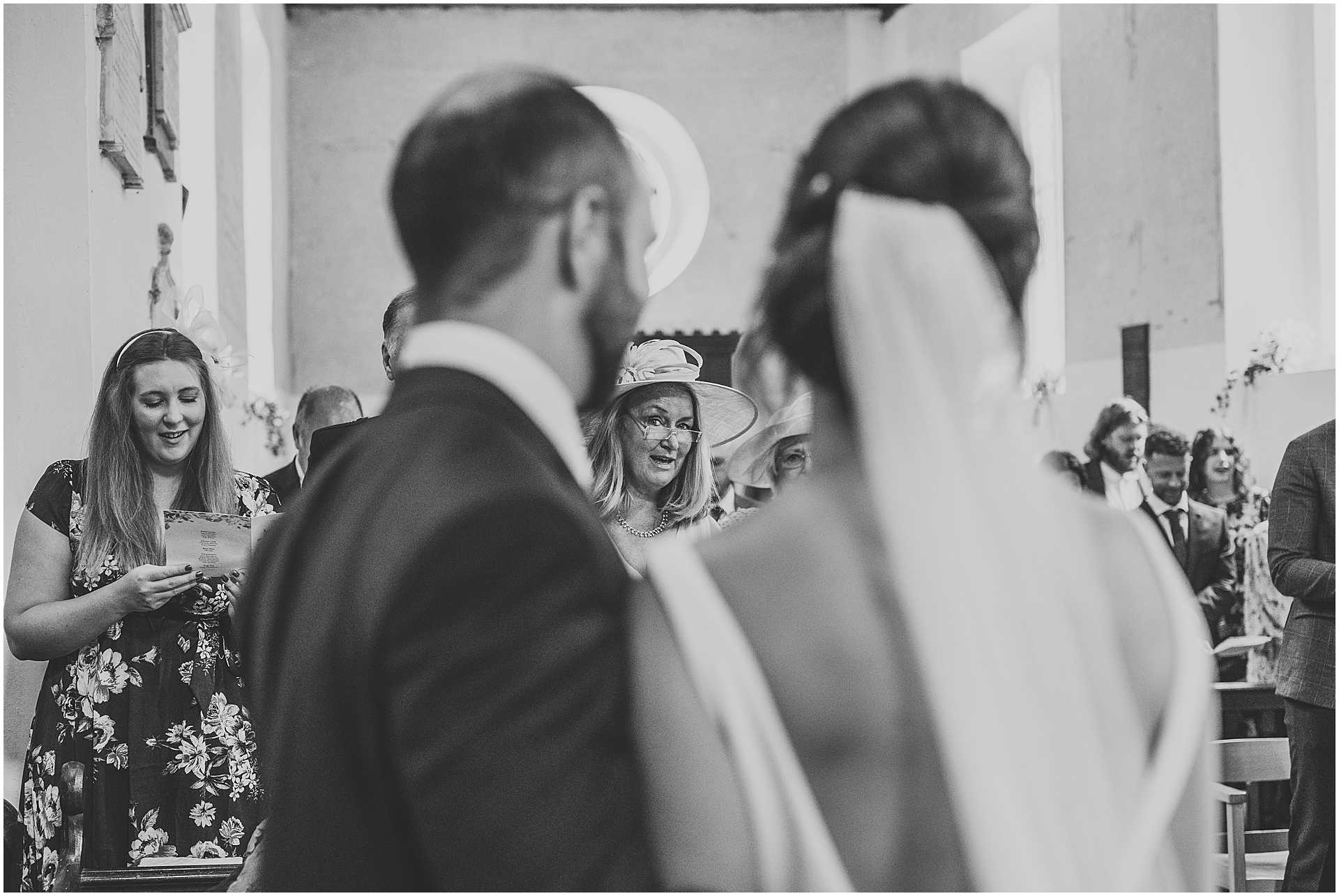 mother of the groom looking at bride during wedding ceremony