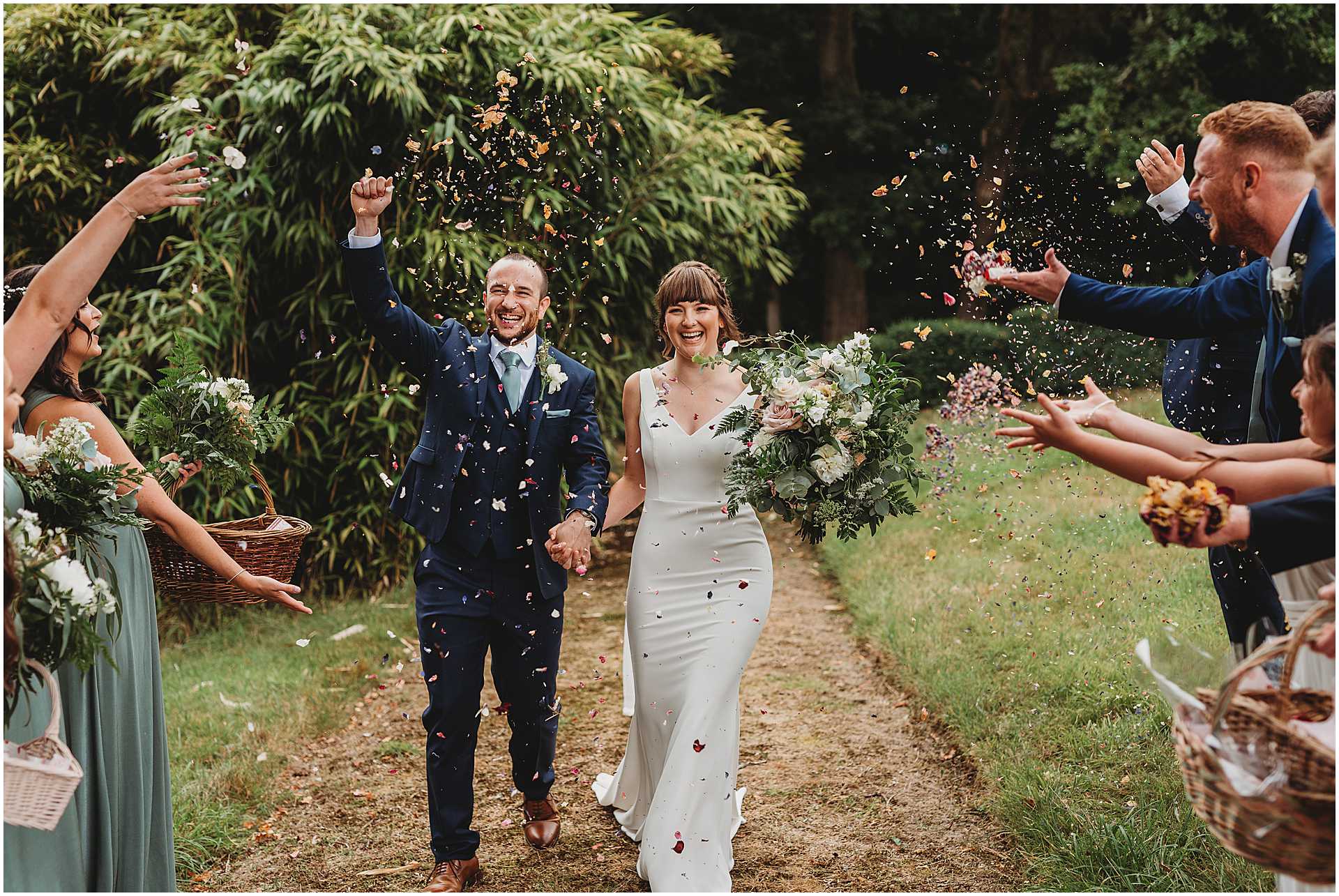 guests throwing confetti over bride and groom