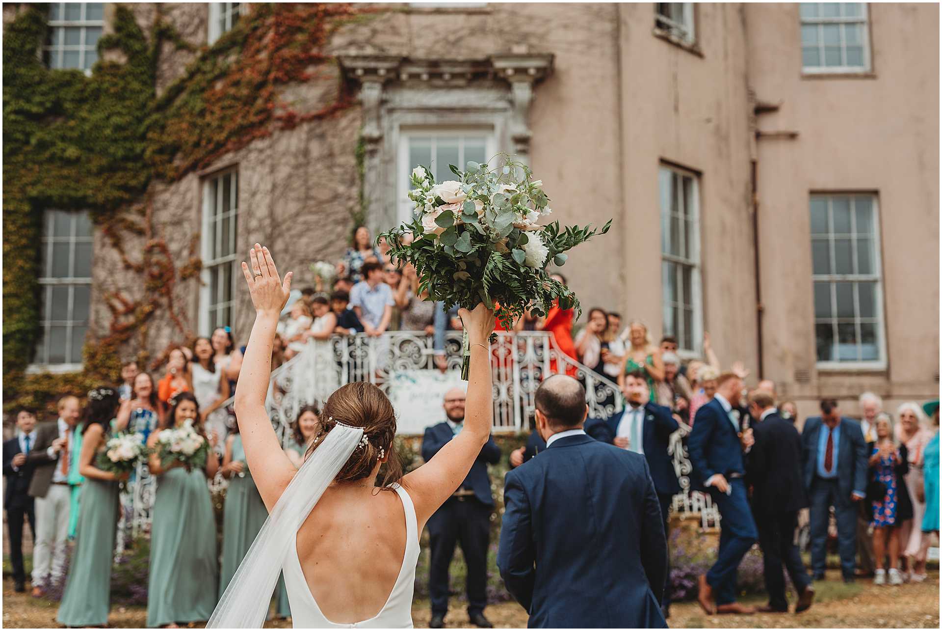 bride throwing bouquet in the air