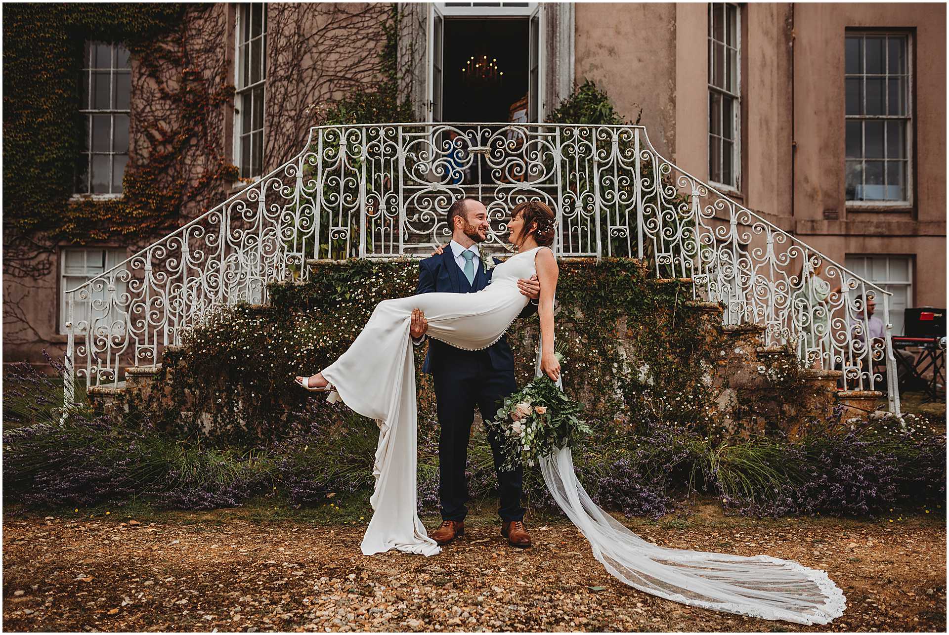 groom carrying his bride