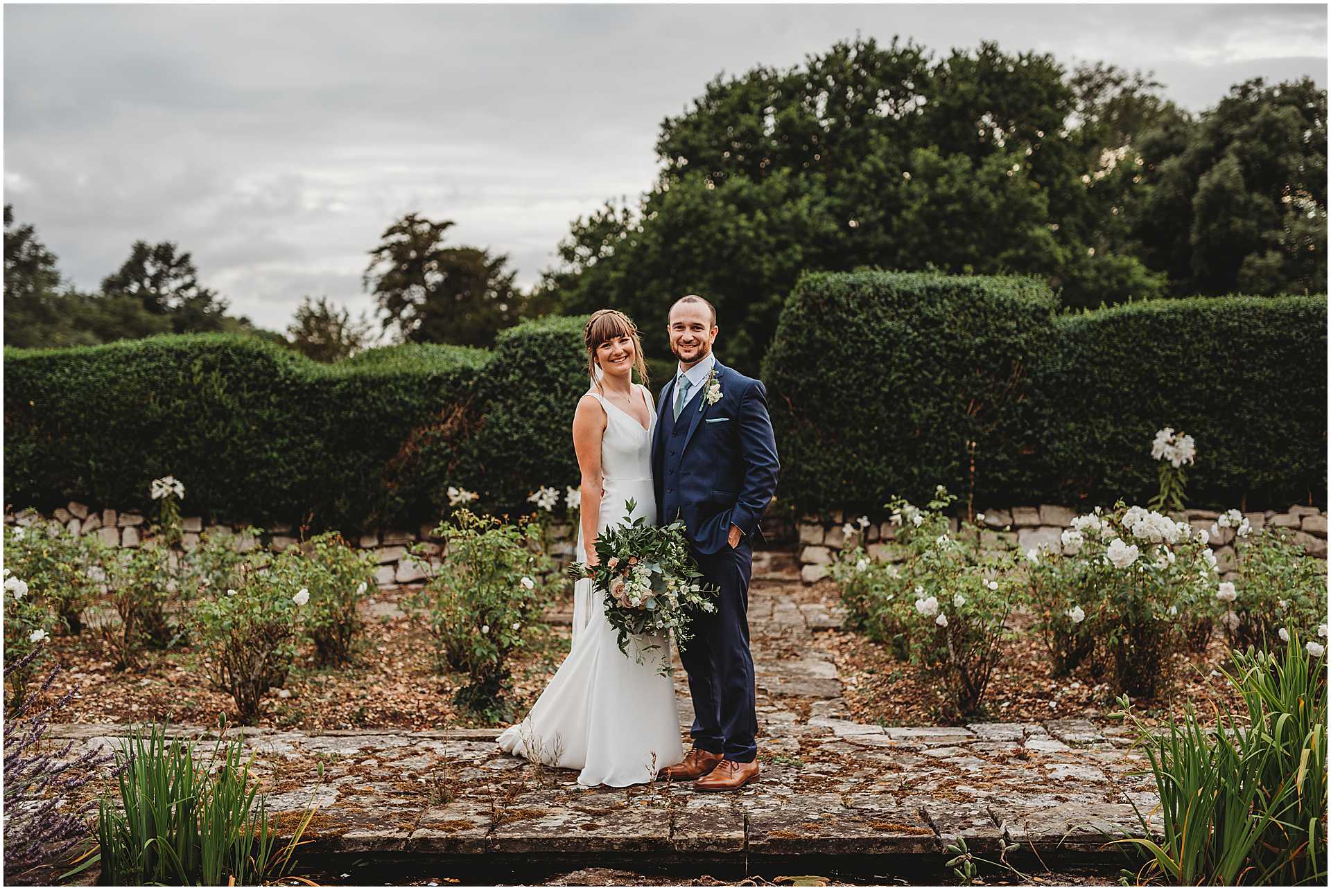bride and groom in the rose gardens at hale park