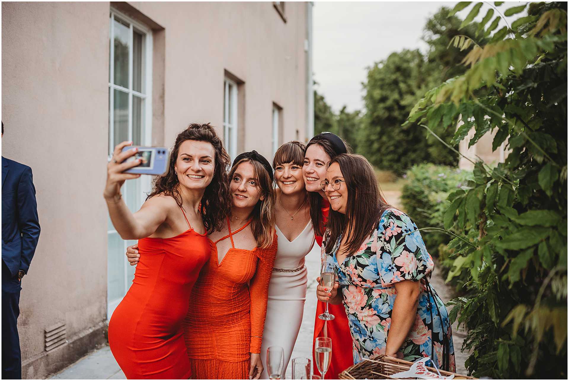 a bride taking a selfie with her friends