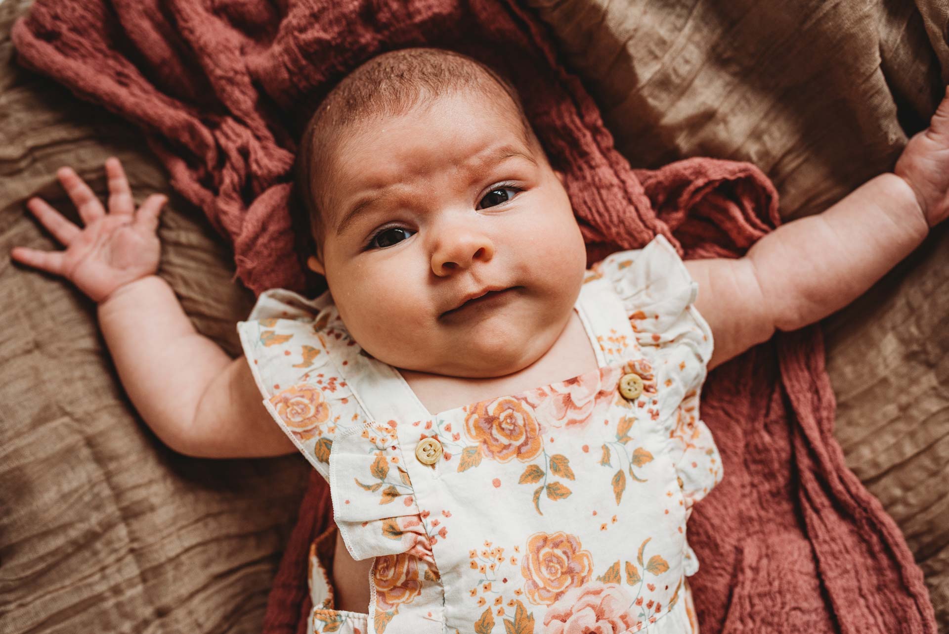 newborn baby lying in her cot