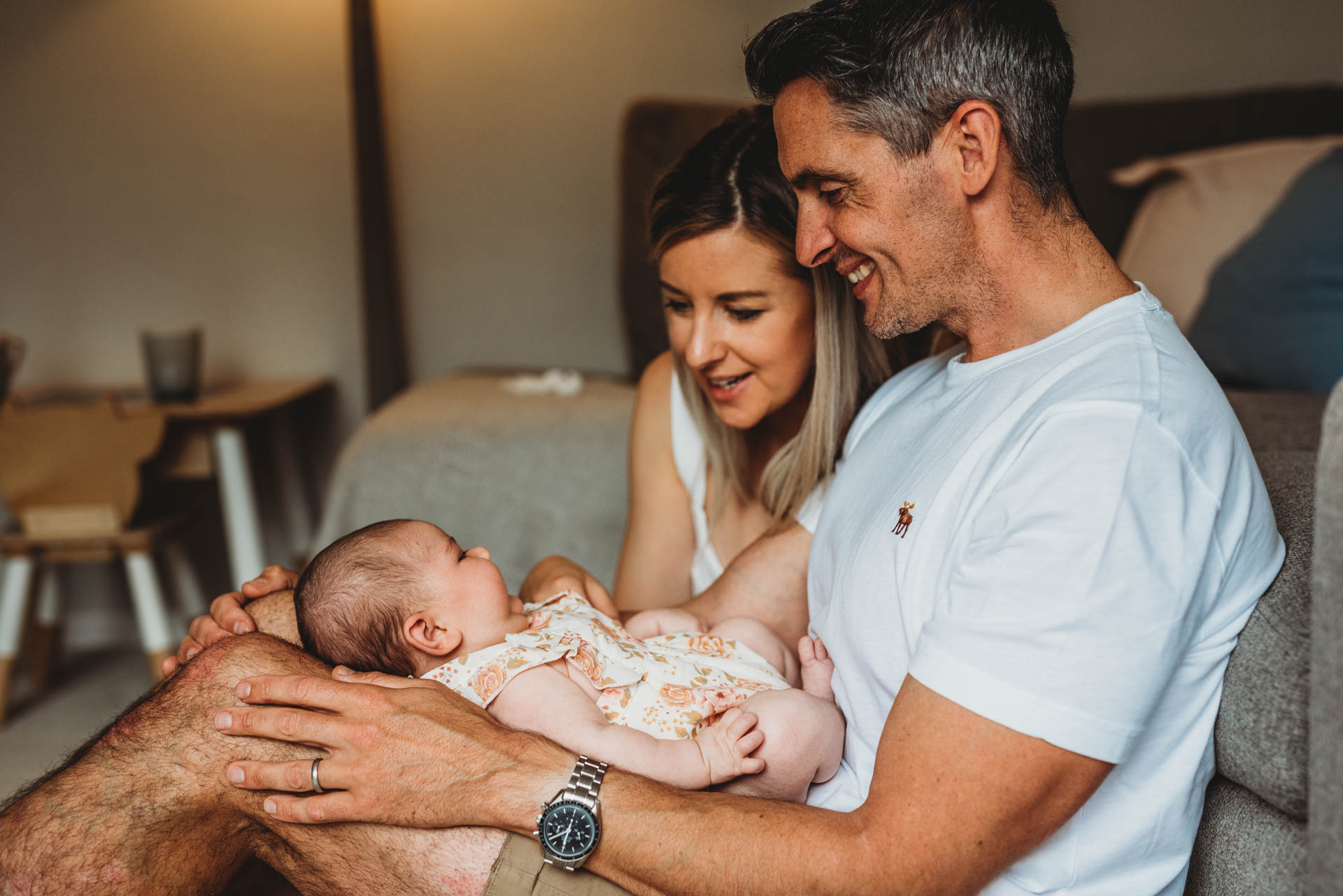 mother and father looking at their newborn baby