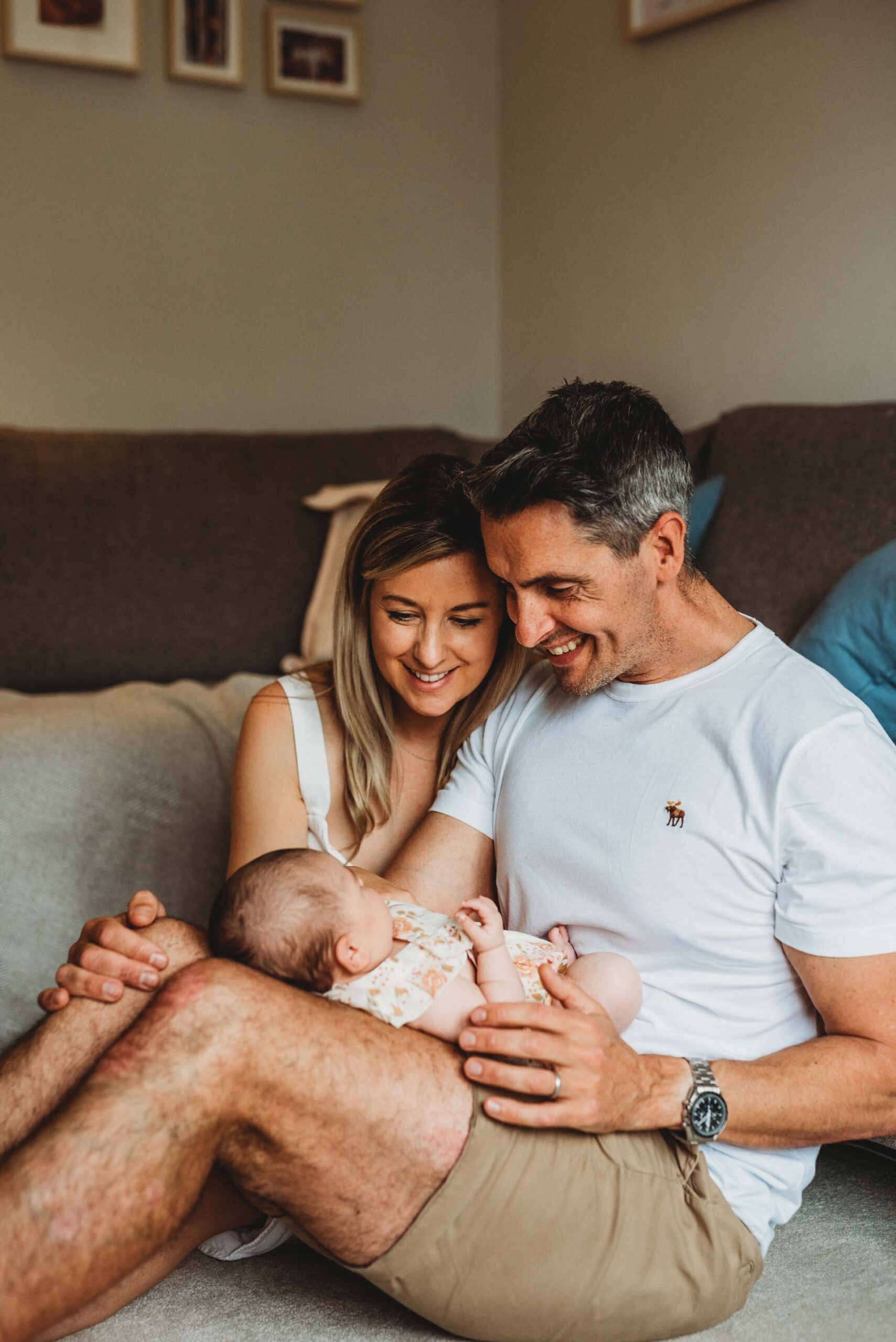 mother and father looking at their newborn baby