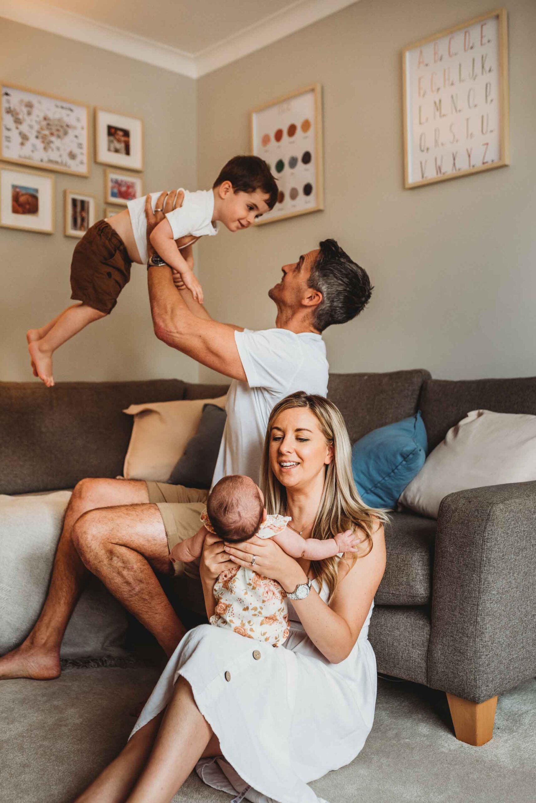 family of four sitting together playing