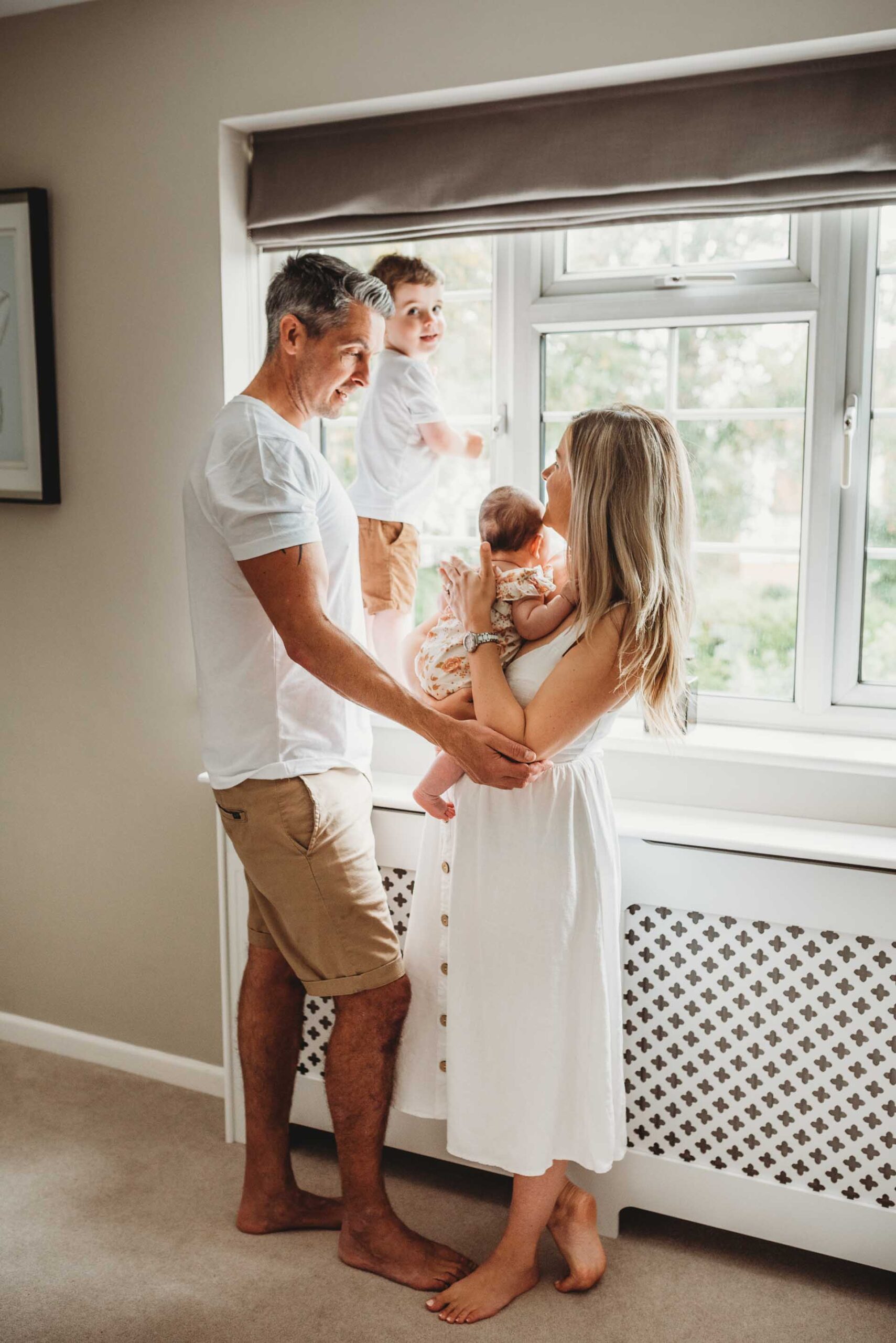 mother and father with little boy and newborn baby
