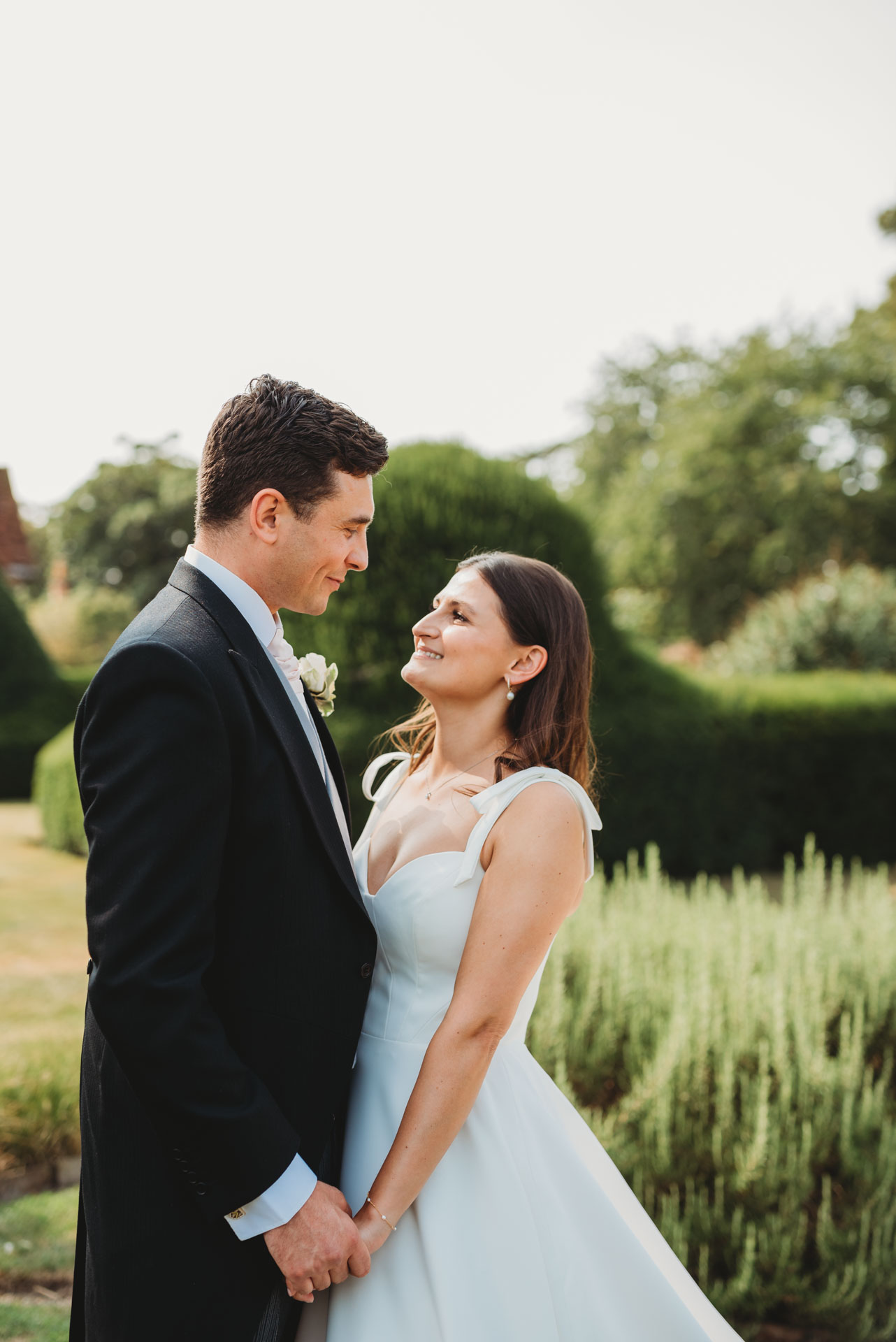 bride and groom portrait in a field by Wedding Photographer in Wiltshire, the Cotswolds, Gloucestershire and beyond. 
