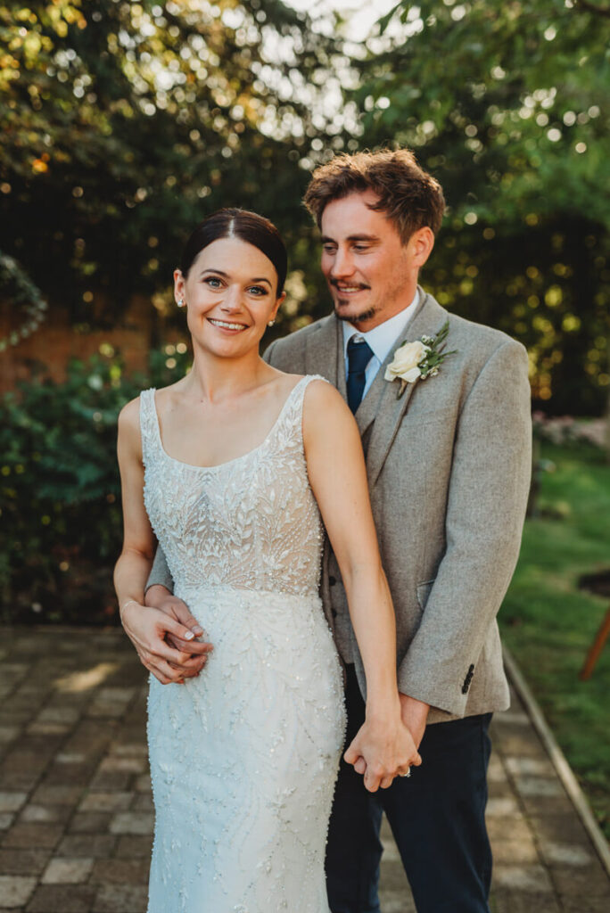 Bride and groom in the garden after saying their vows at their elopement bu small wedding photographer in Wiltshire