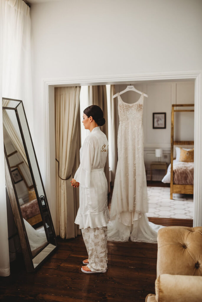 bride waiting to put her dress on in the bridal suite at Syrencot house.