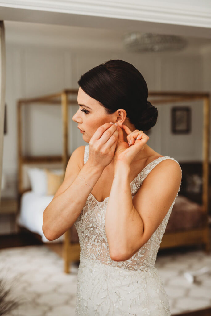 bride putting her earrings in