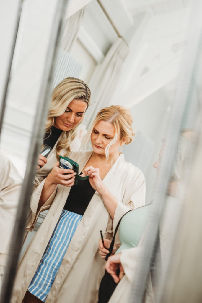 bridesmaids looking at their phones whilst getting ready at Syrencot house