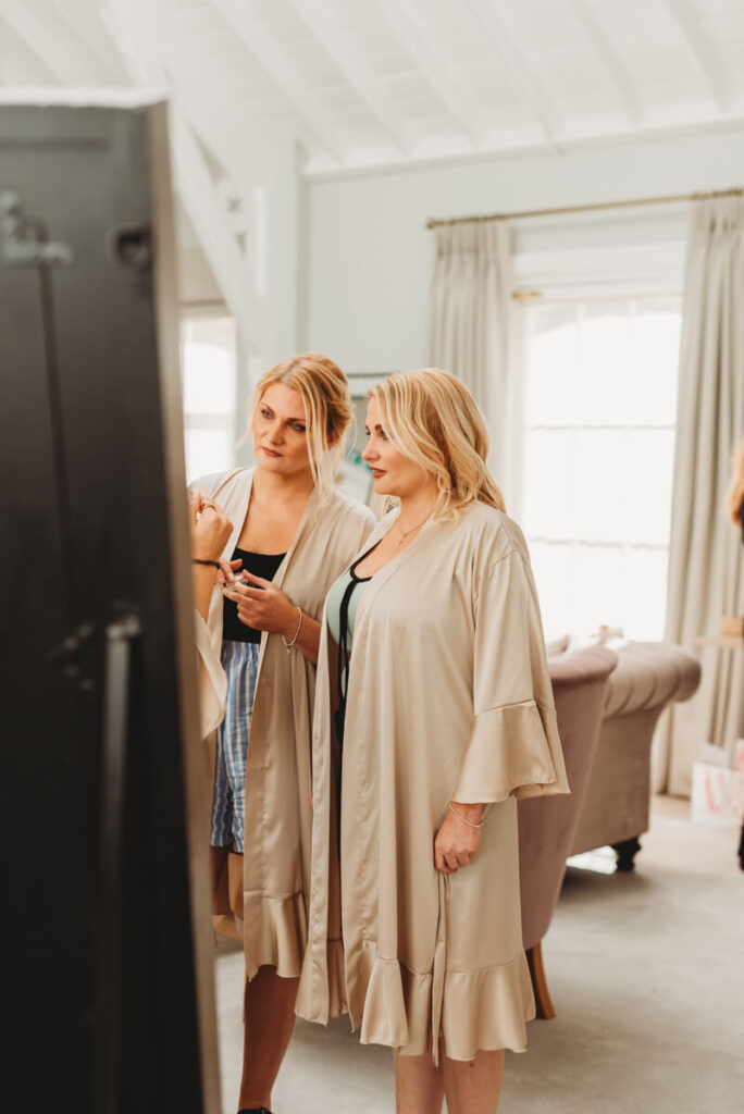 bridesmaid chatting to each other whilst getting ready at Syrencot house