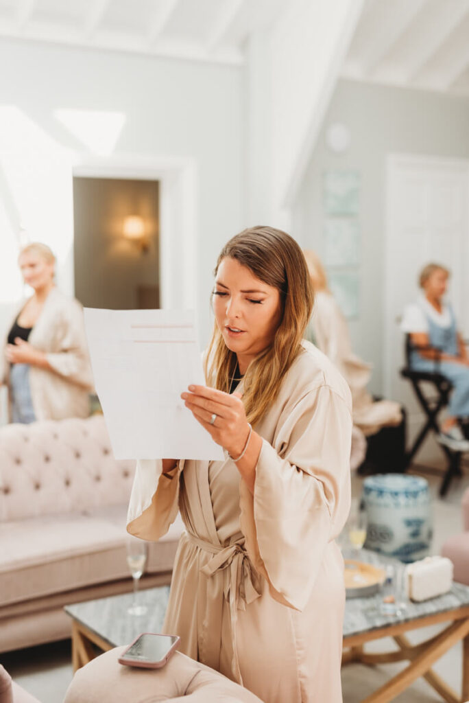 bridesmaid checking the wedding day schedule whilst getting ready