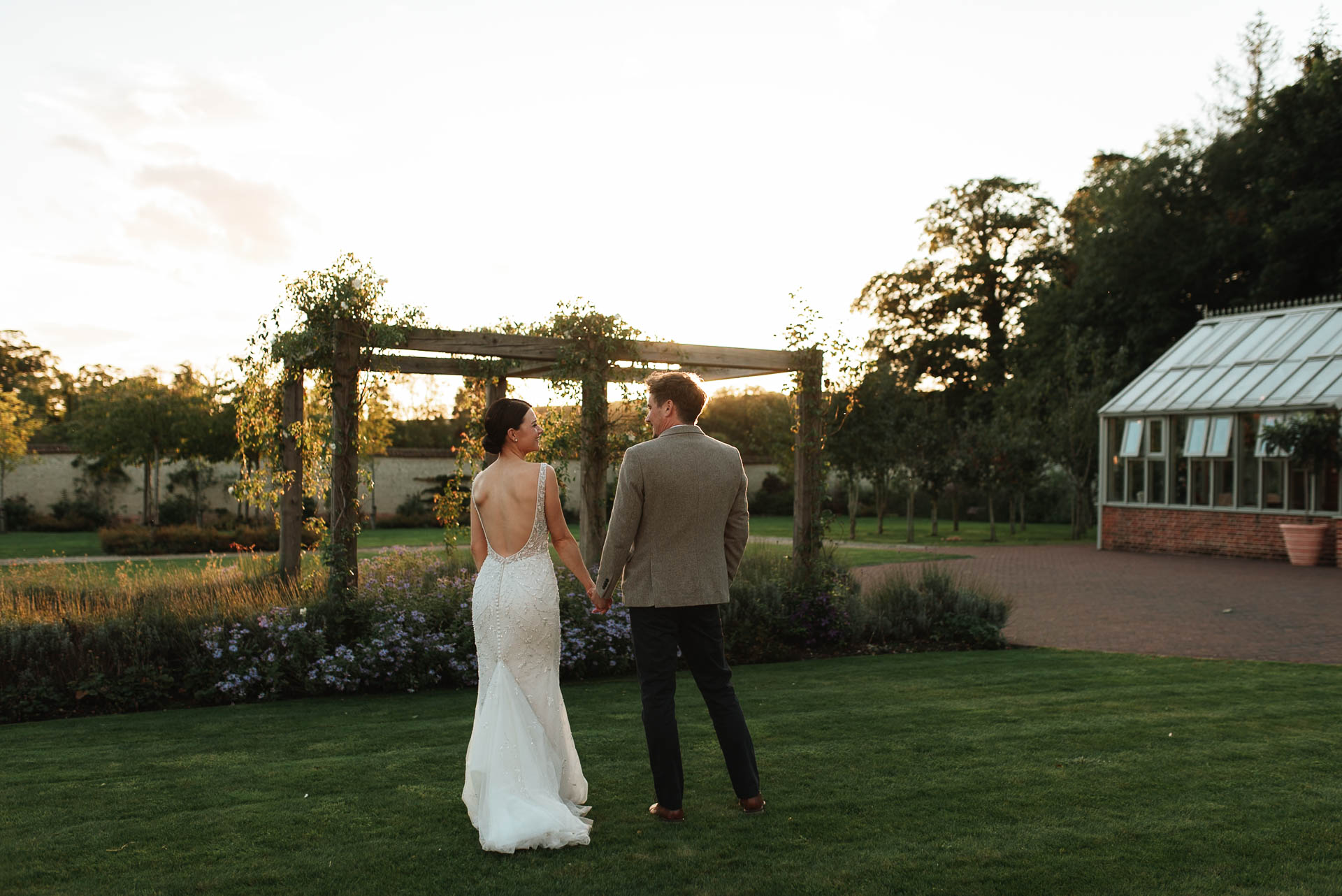 bride and groom standing side by side in sunset at syrencot house