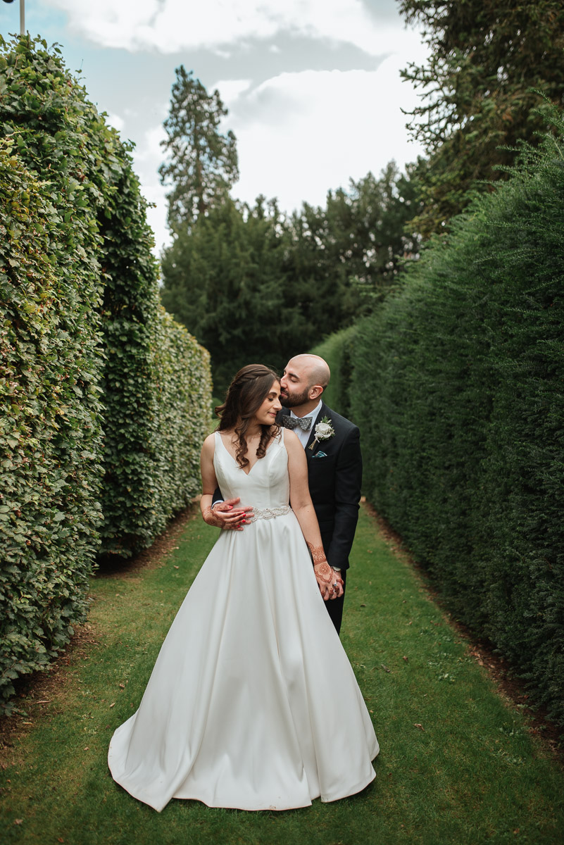 elegant bride and groom sharing intimate moment in the gardens at grittleton house, natural light golden hour