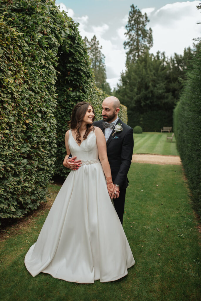 Outdoor couple portrait in a Cotswolds garden at a relaxed wedding