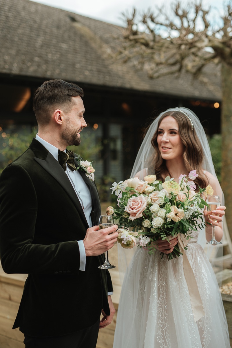 Bride and groom sharing their first drink after their micro wedding ceremony at a Gloucester wedding venue