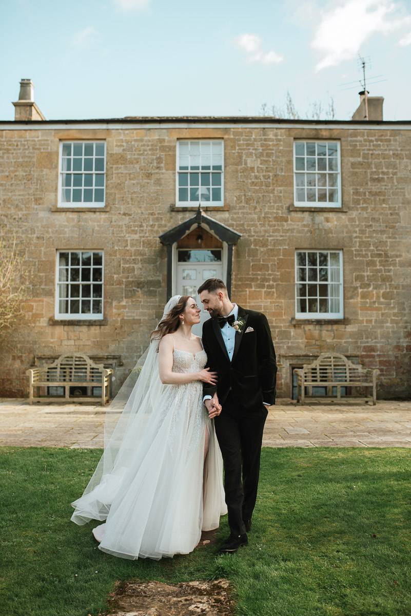 bride and groom walking linking arms at Capstone barn wedding venue