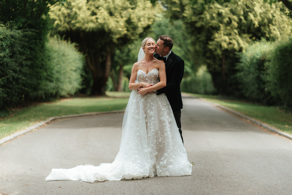 bride and groom share intimate moment after their elegant wedding ceremony at the Post Barn Berkshire wedding venue
