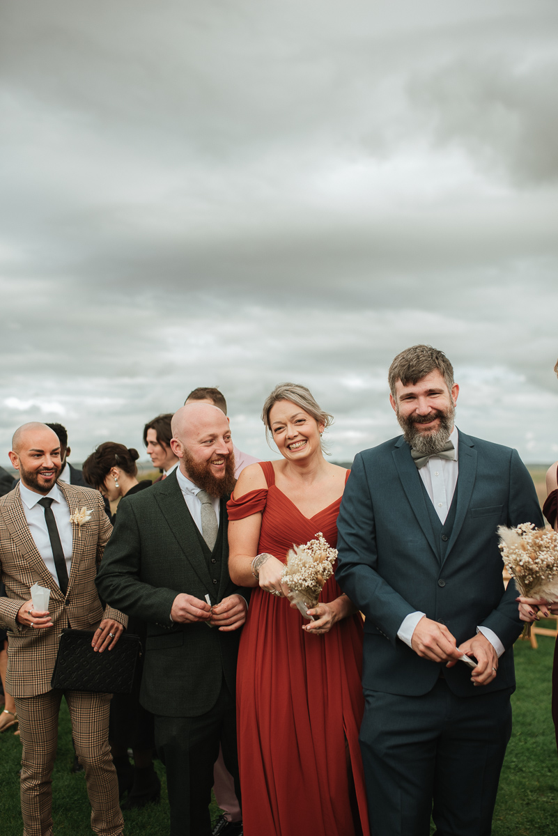 guests waiting to throw confetti at chalk barn Wiltshire wedding venue