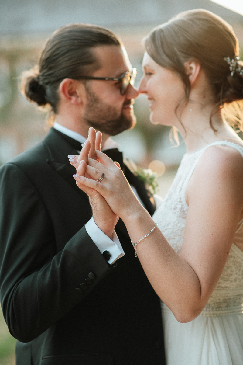 romantic bride and groom portrait at golden hour, intimate wedding photography with soft natural light.
