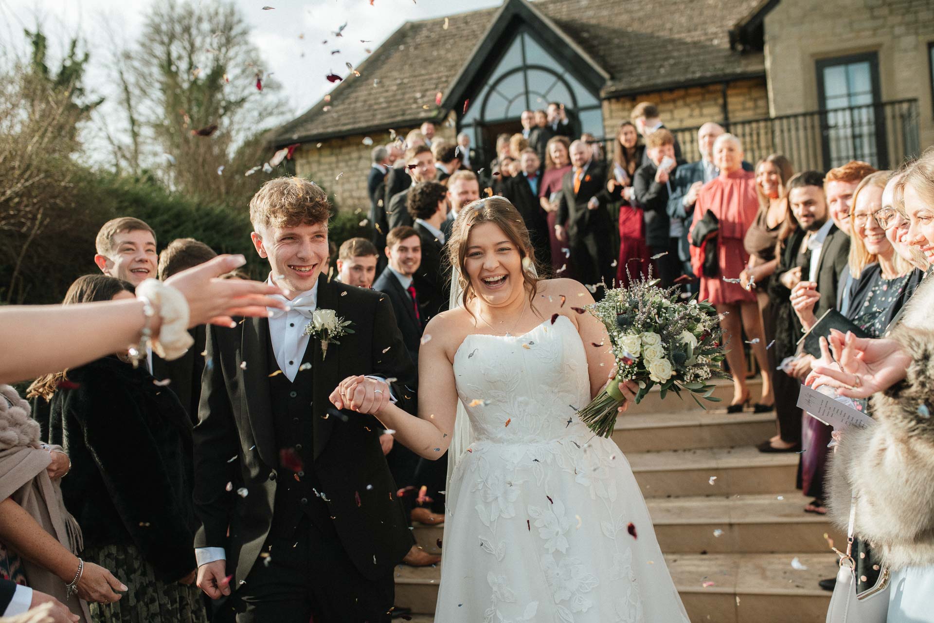 confetti shot on the steps at the pear tree purton wedding venue