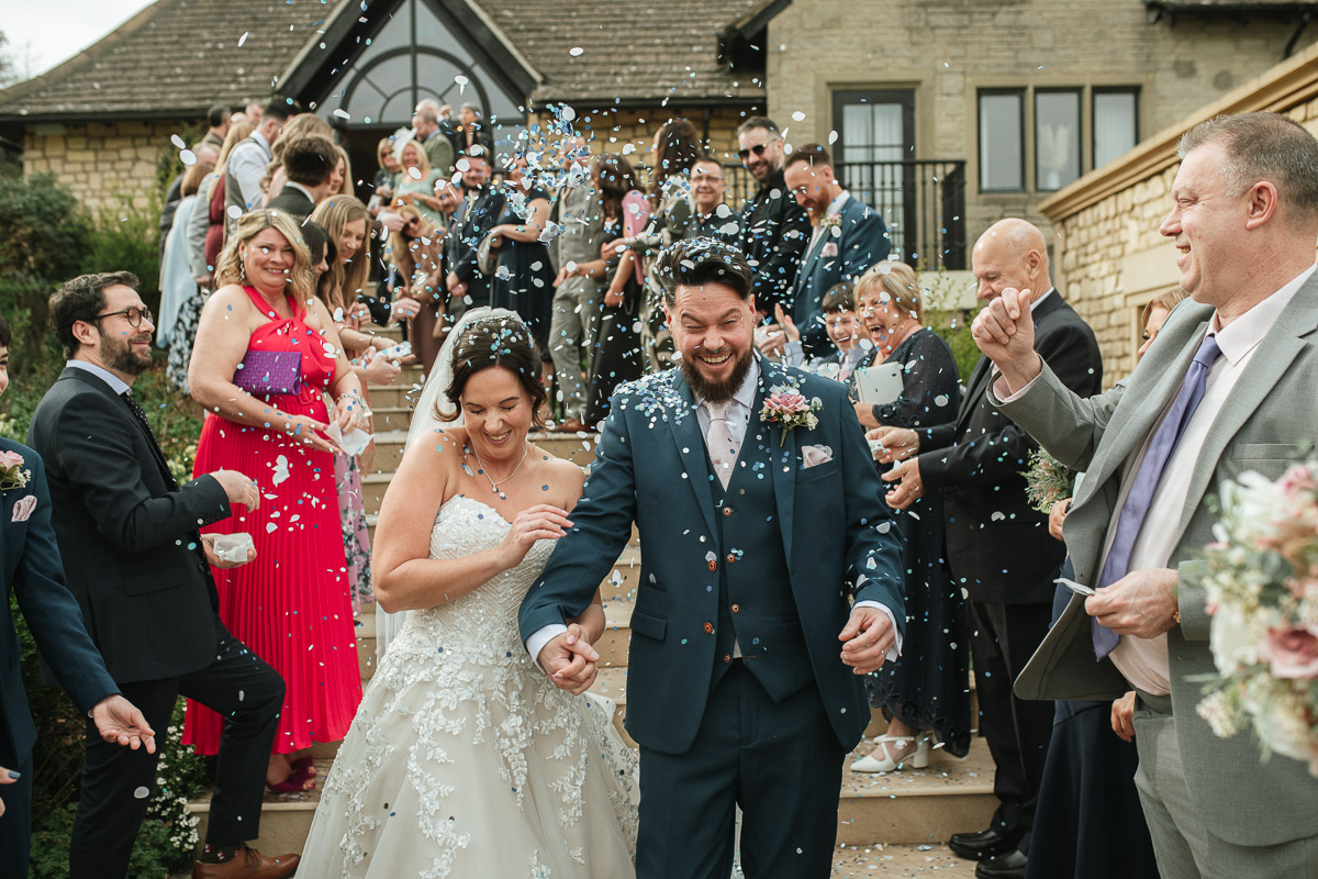 confetti shot on the steps at the pear tree purton wedding venue