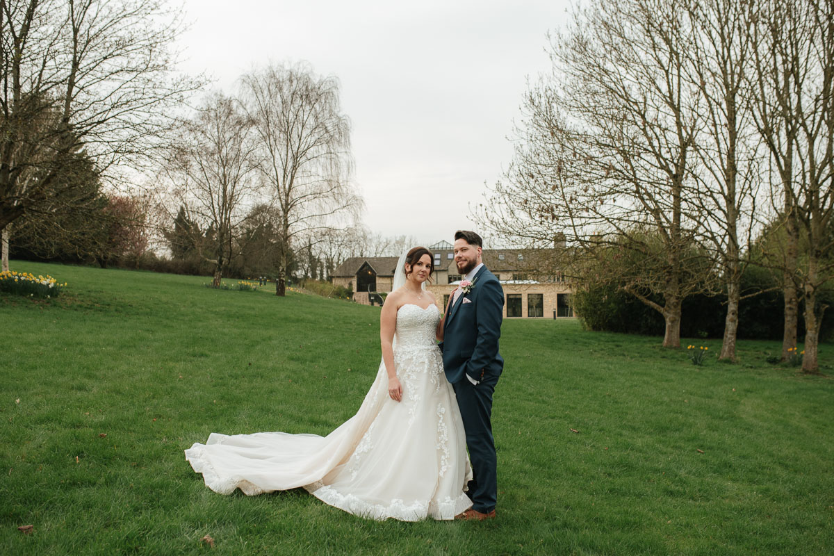 Relaxed bride and groom portrait at the pear tree as part of short wedding photography coverage in Gloucestershire.