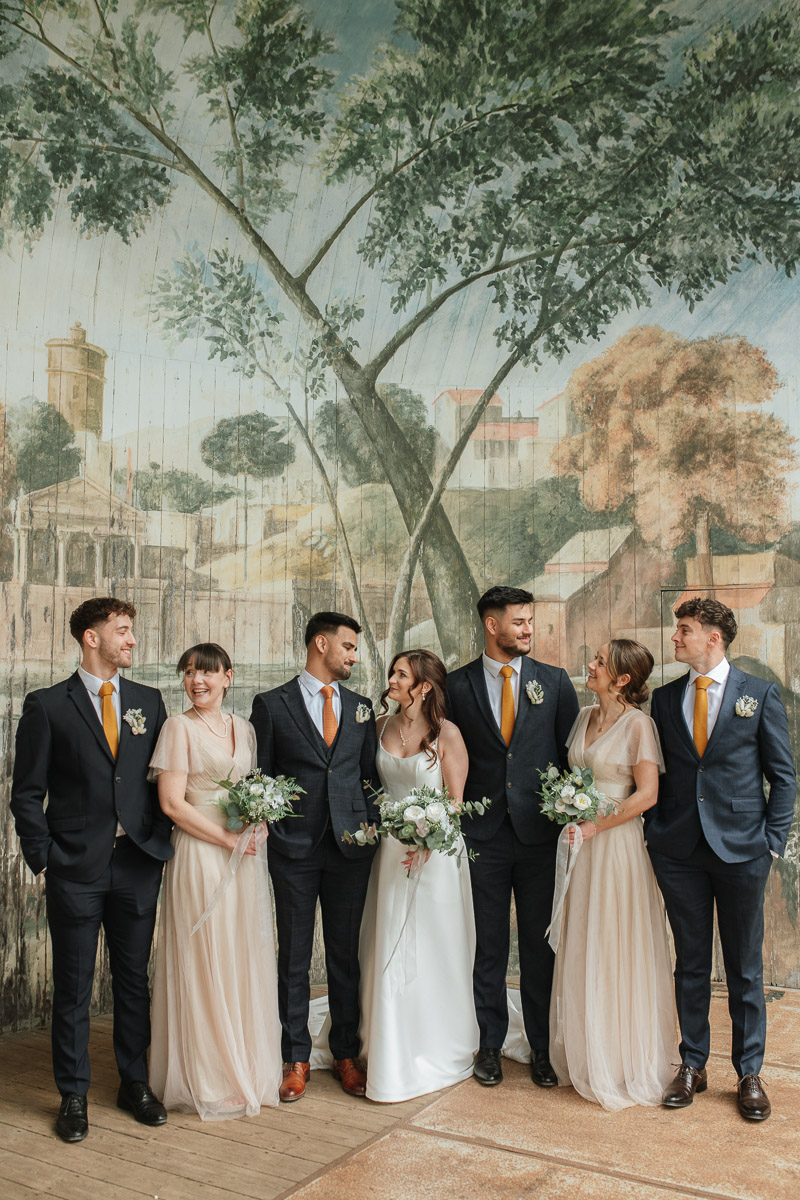 bridal party group photo in the pavilion at the larmer tree gardens wiltshire