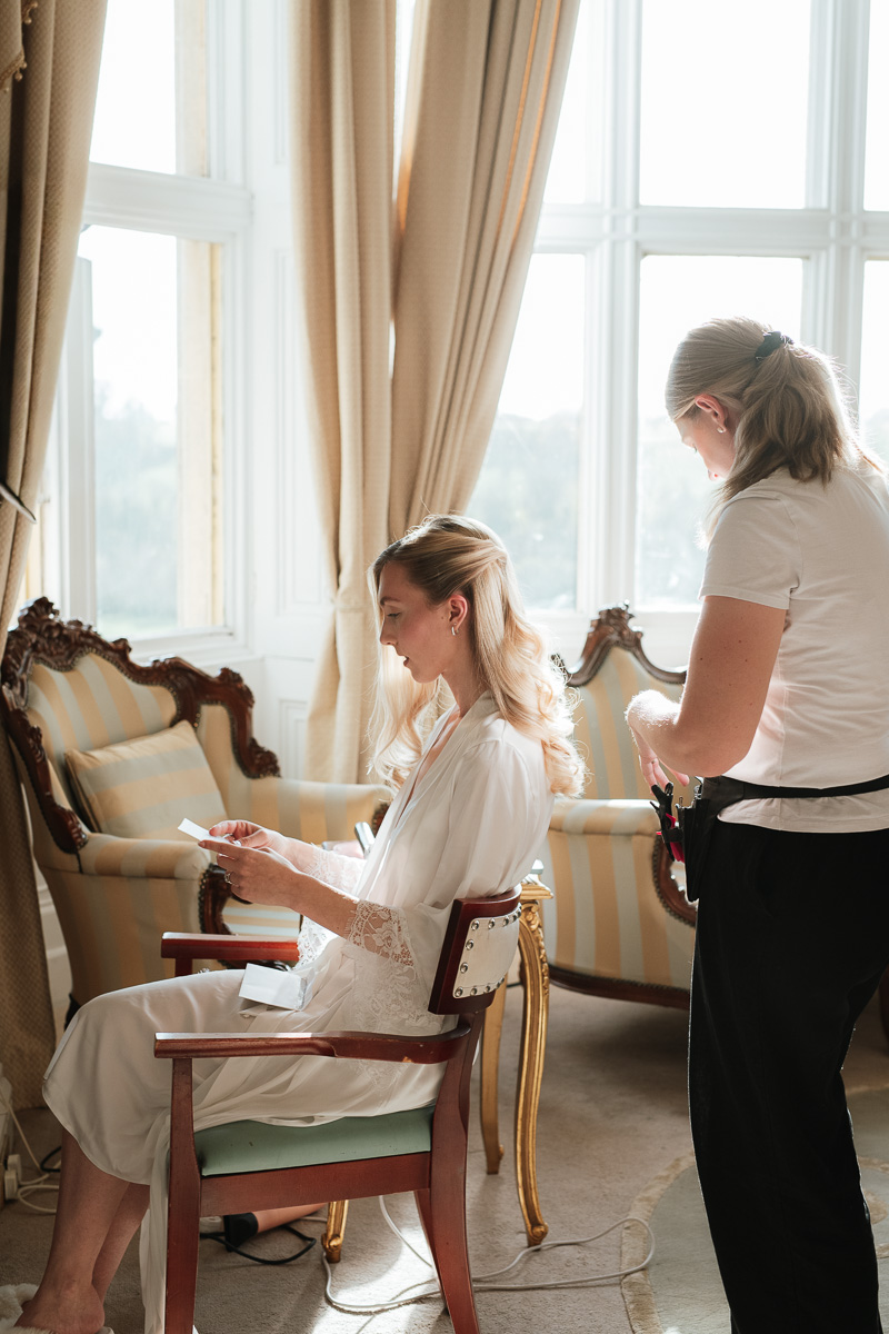 bride reading a letter from her groom at orchardleigh estate wedding venue