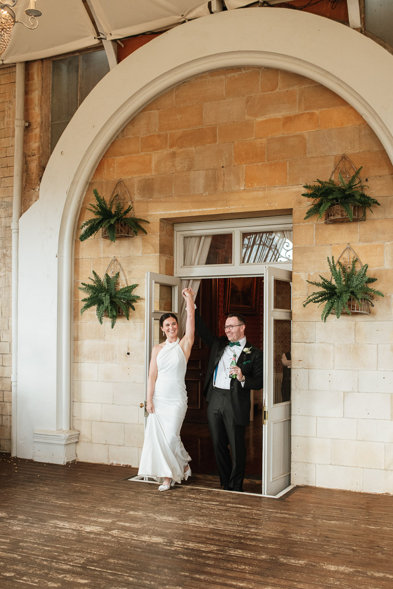 bride and groom walking into wedding breakfast at grittleton house