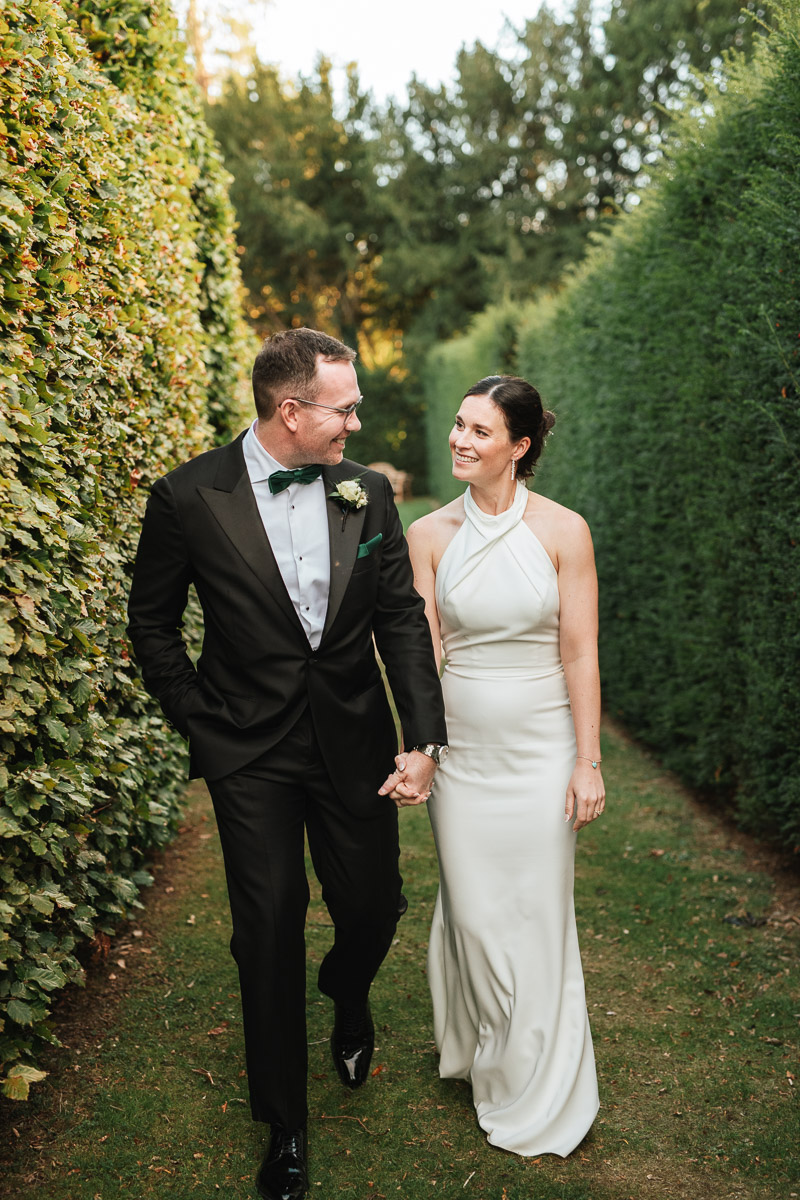 bride and groom walking through the garden at grittleton house wedding venue