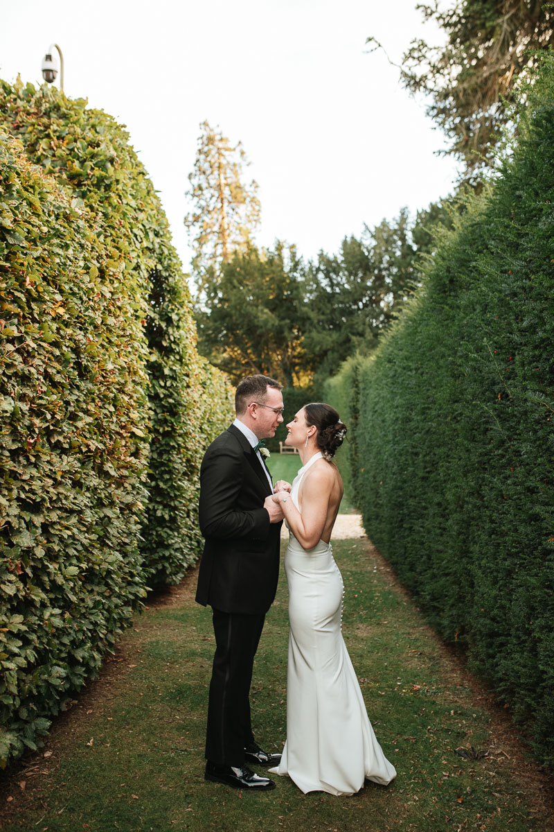 bride and groom standing facing each other in the gardens at grittleton house wedding venue